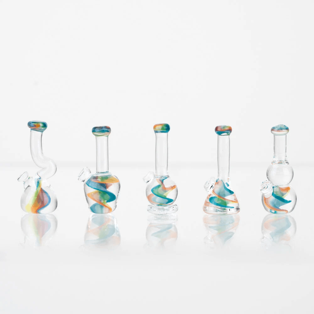 Five piece set of lego bongs with a rainbow swirl in the middle of the bong. The rainbow swirling is in the base and mouth piece of the bong.