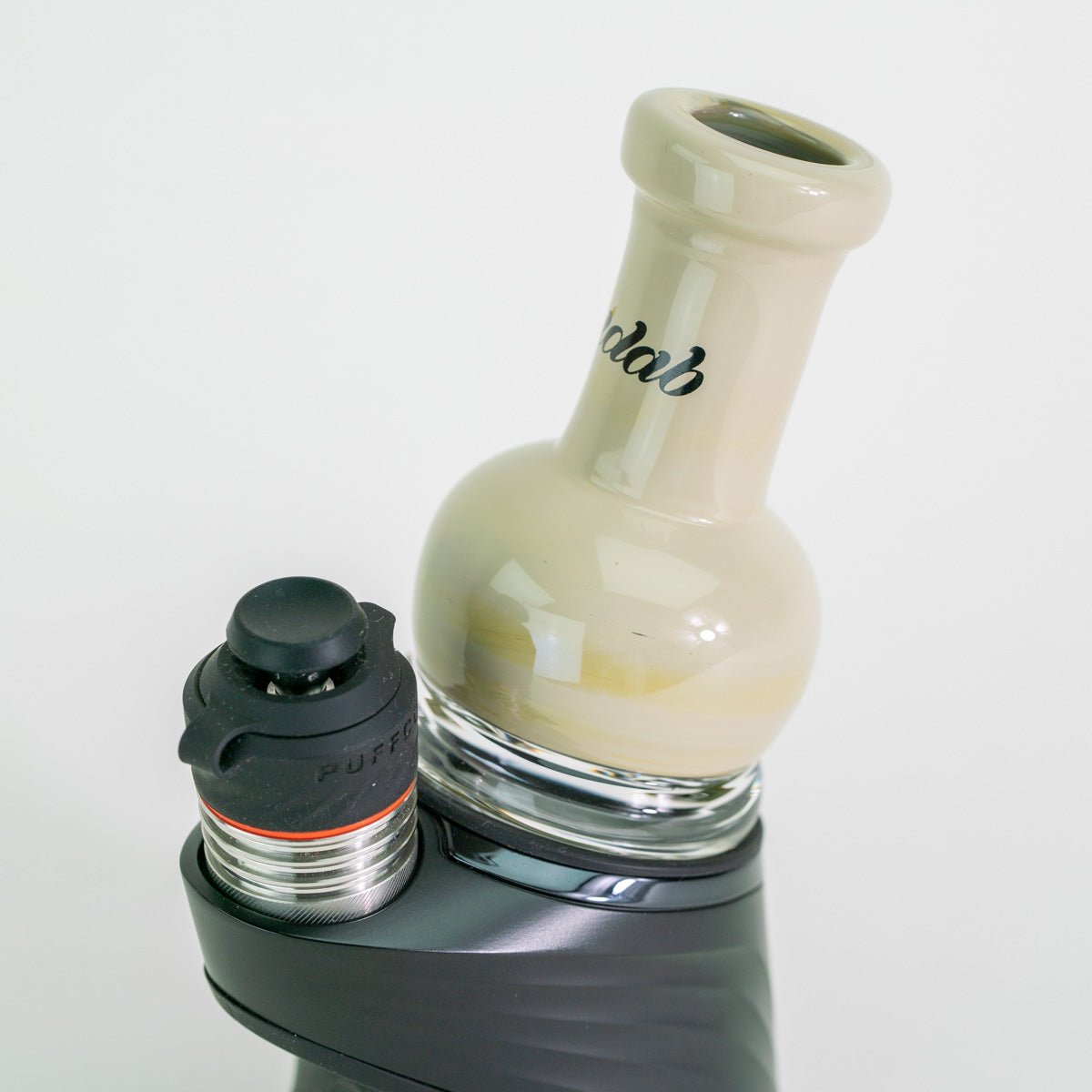 Cream colored glass attachment for Puffco device