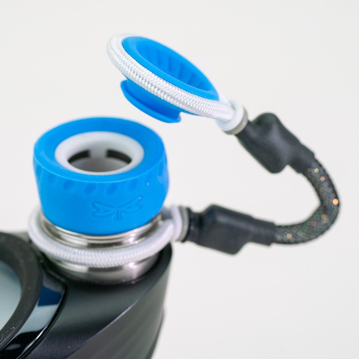 Closeup of blue and black Puffco attachment piece on white background