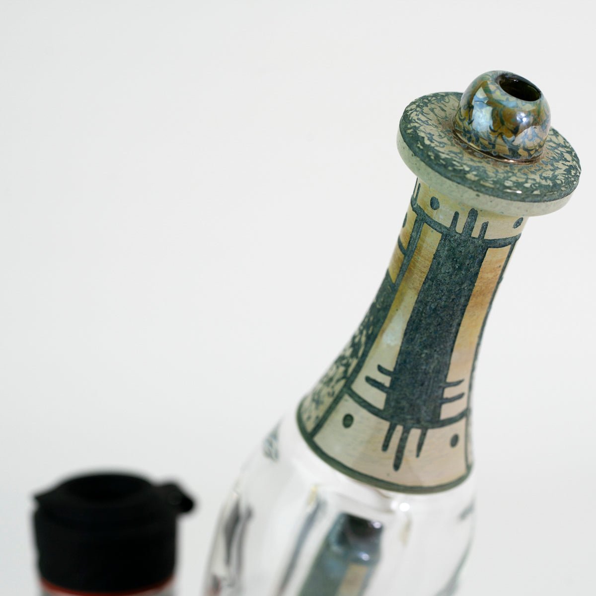 Closeup top of glass water peak attachment on white background