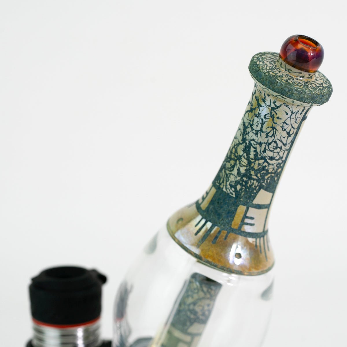 Closeup of glass green engraved water peak accessory