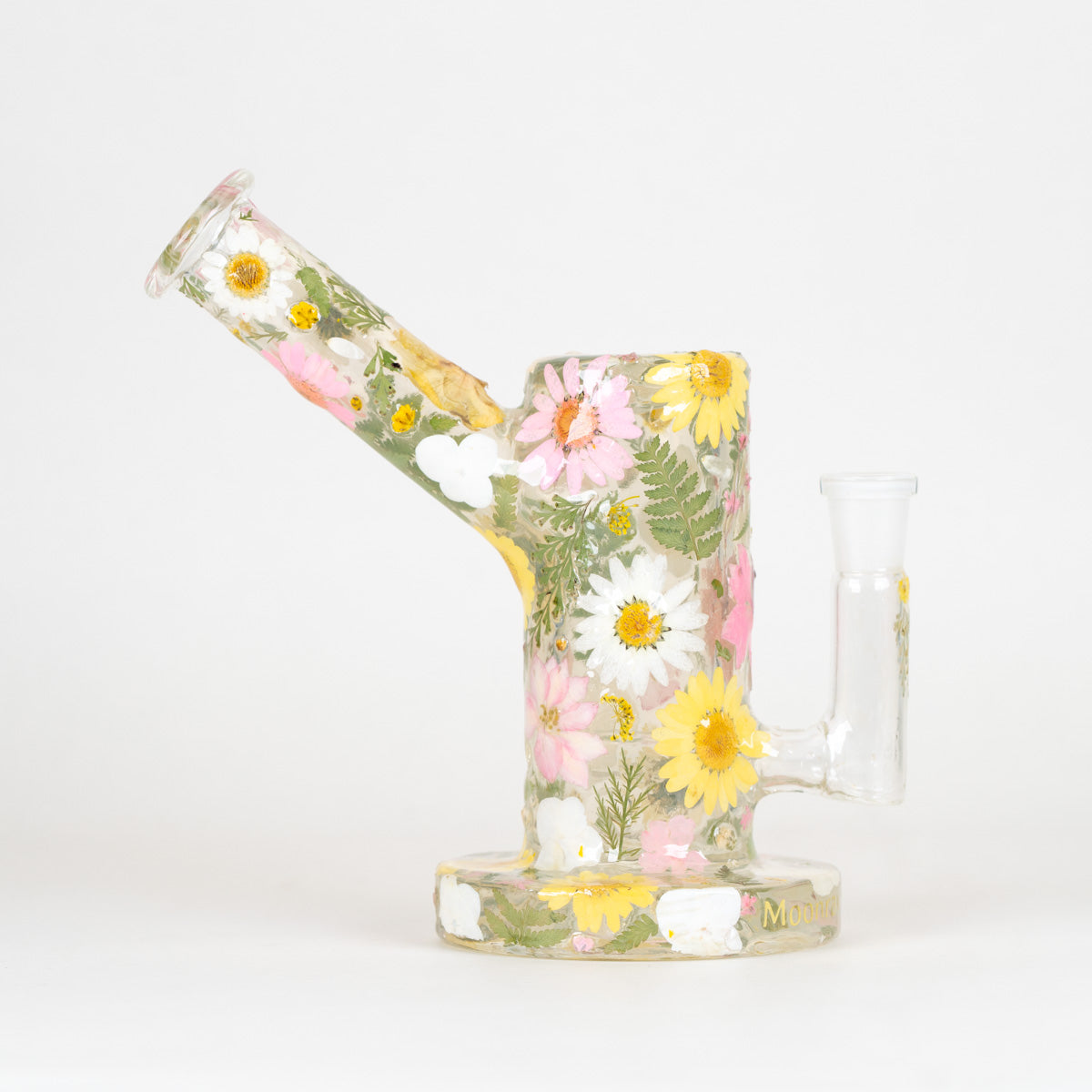 A clear glass water pipe with a floral design featuring pressed-style pink, white, and yellow flowers with green leaves, set against a plain white background.