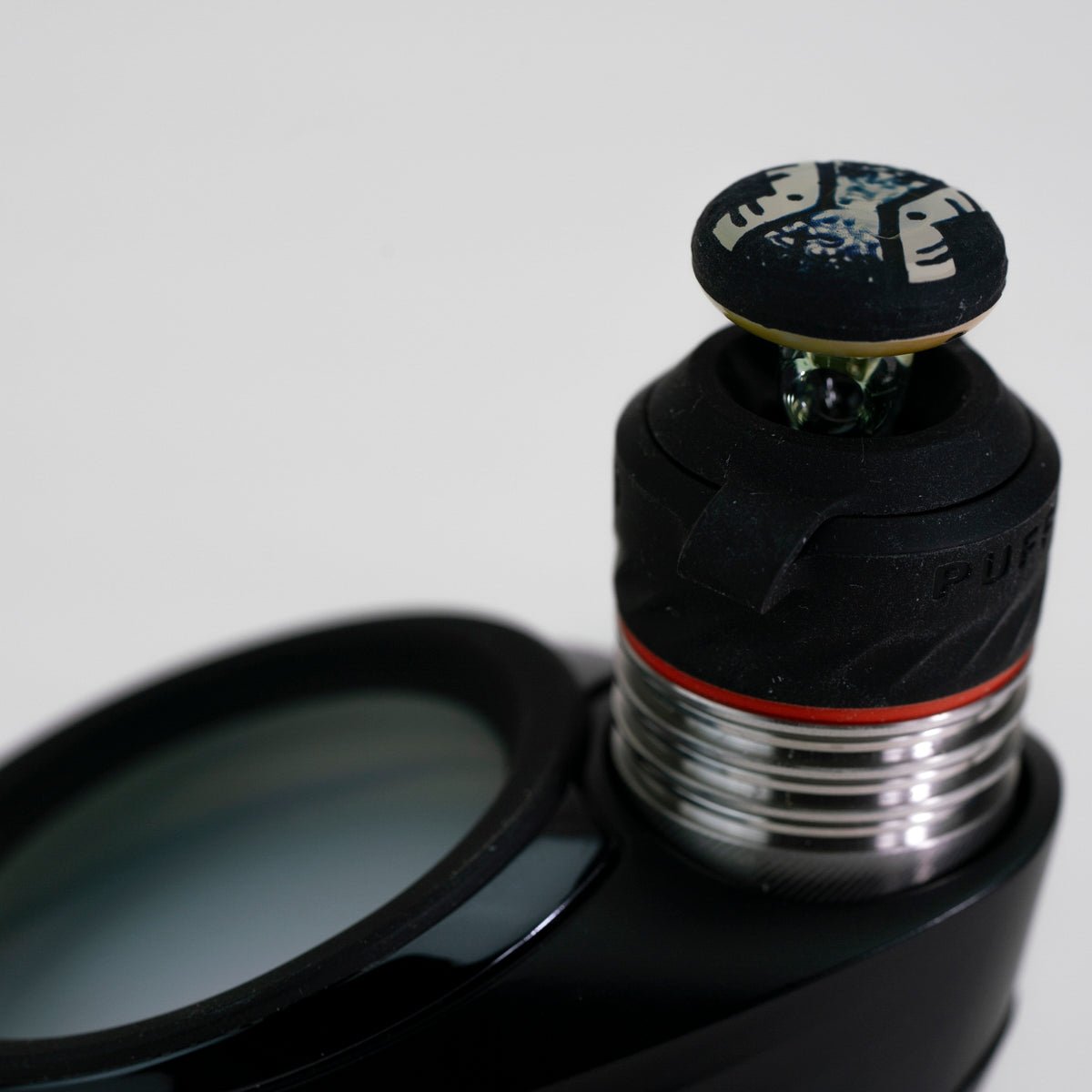 Closeup of engraved joystick accessory on white background