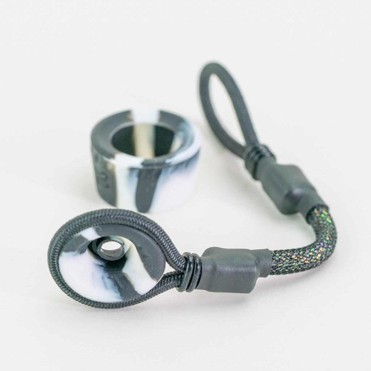 Black and white tuff tether attachment laying on white background