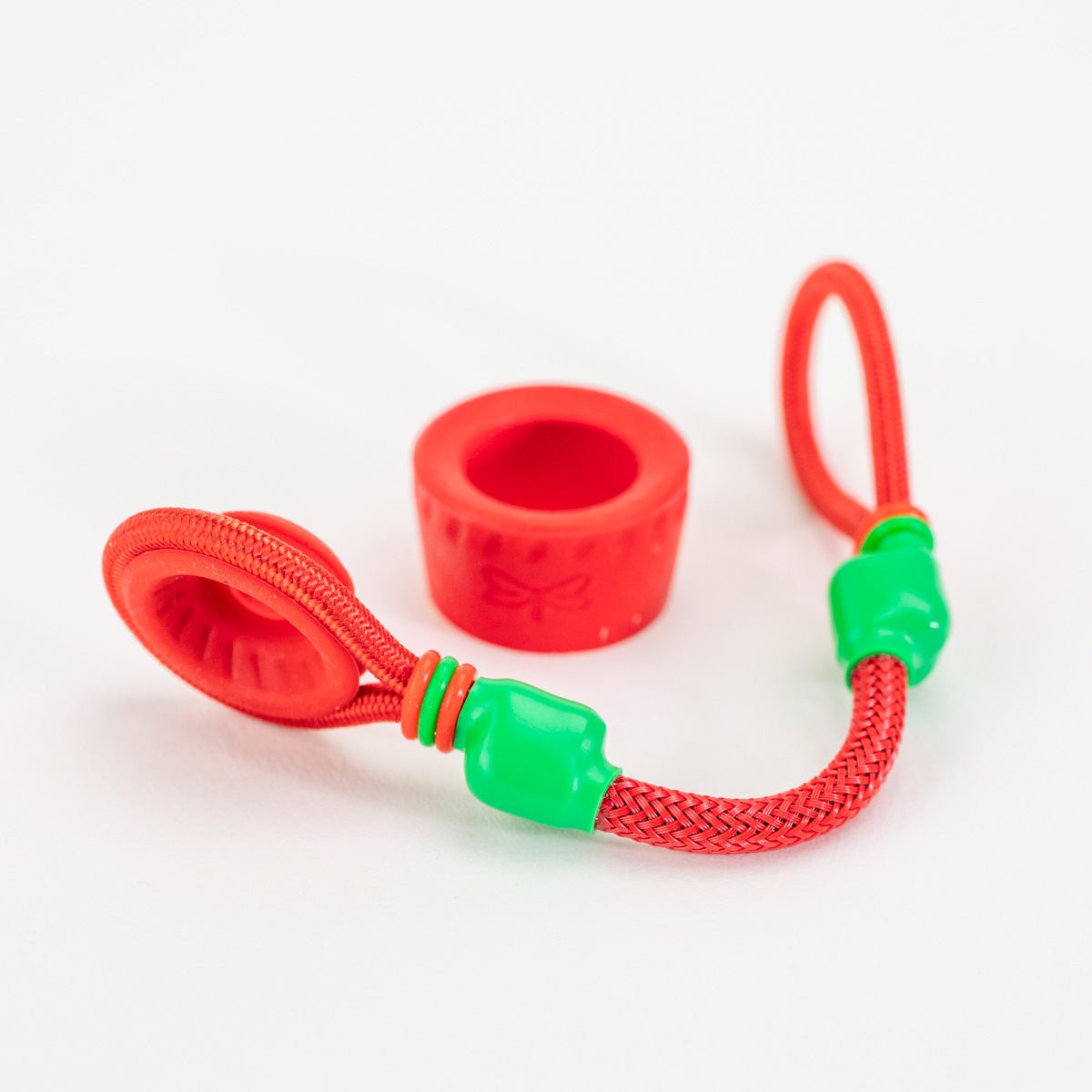 Red and green tuff tether accessory laying on white background
