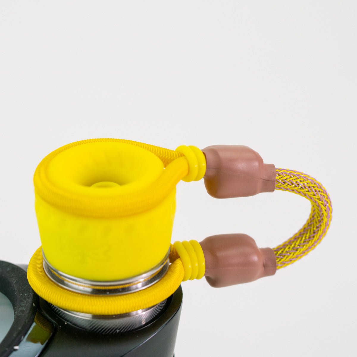 Yellow and brown attachment on Puffco Peak Pro device