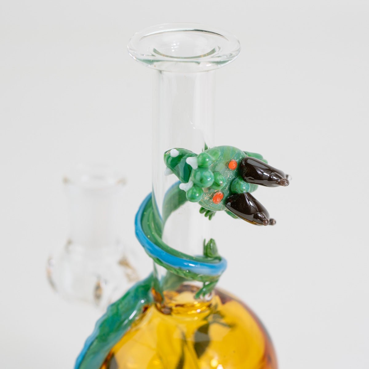 Closeup of glass dragon on mini tube