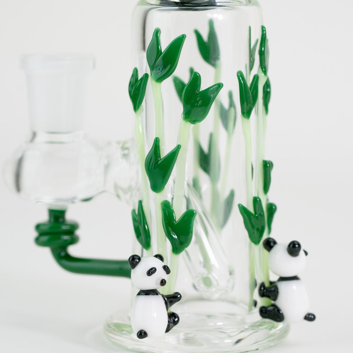 Two glass pandas on a nano rig with bamboo