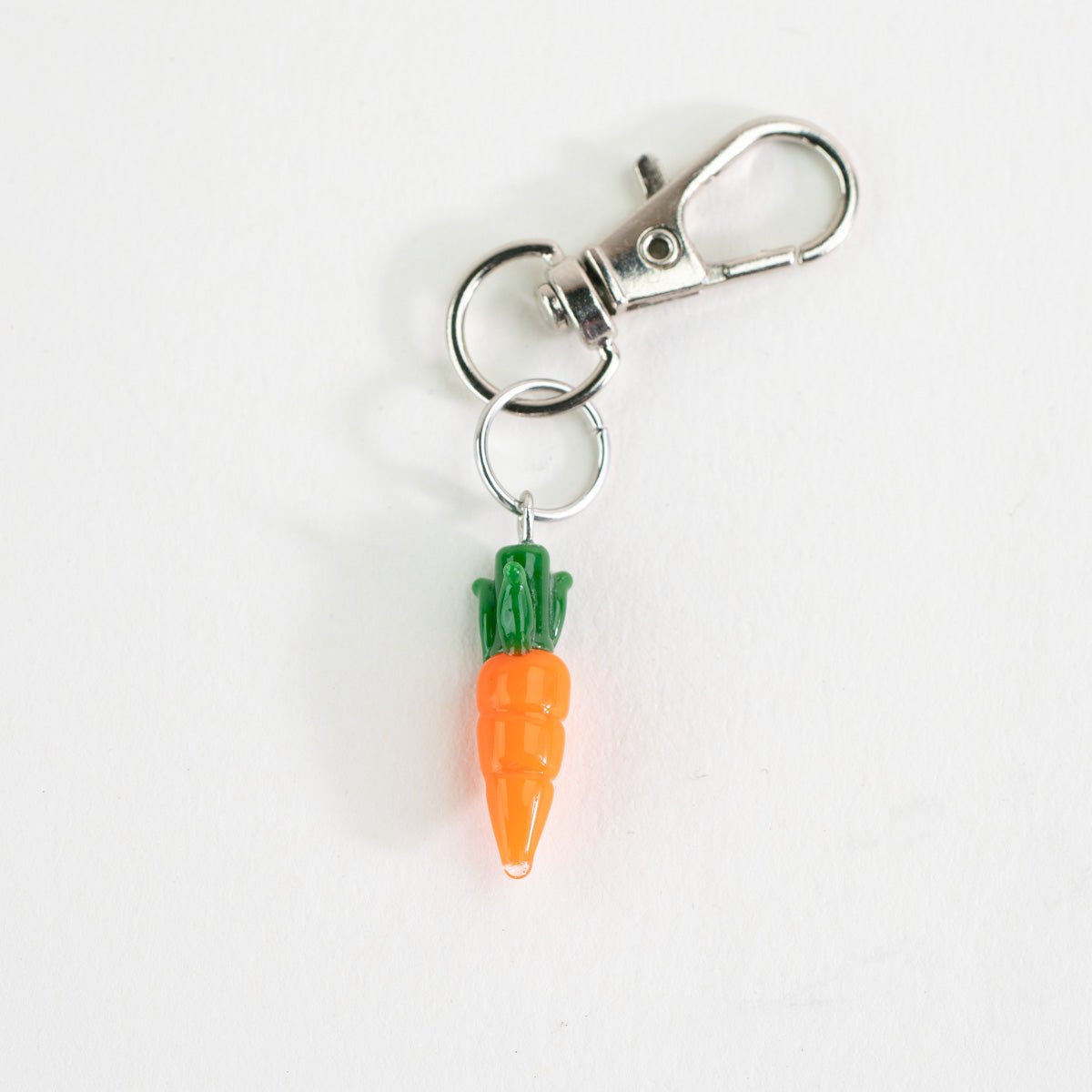 Cute carrot glass charm styled as a Puffco accessory