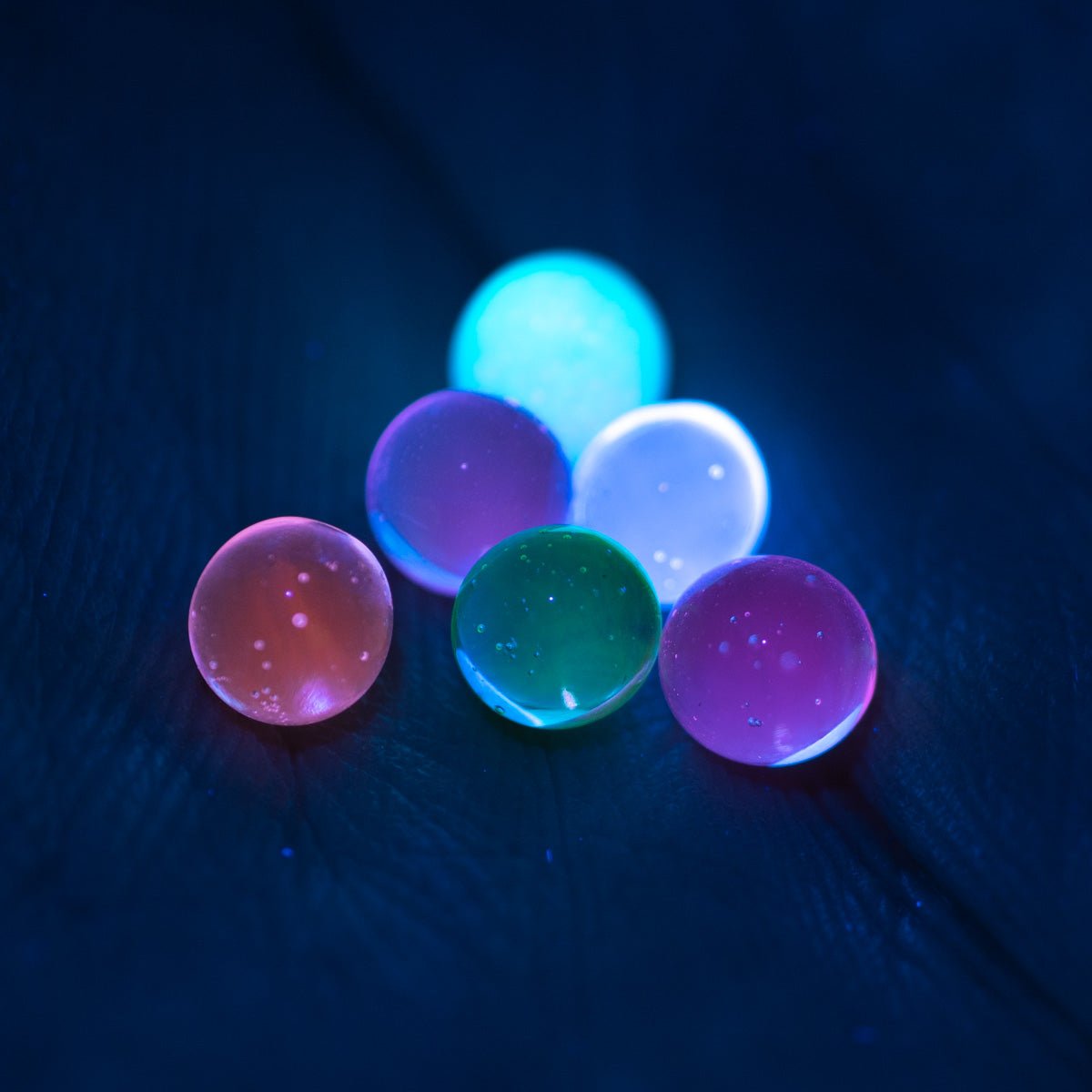 UV reactive terp pearls glowing under blacklight