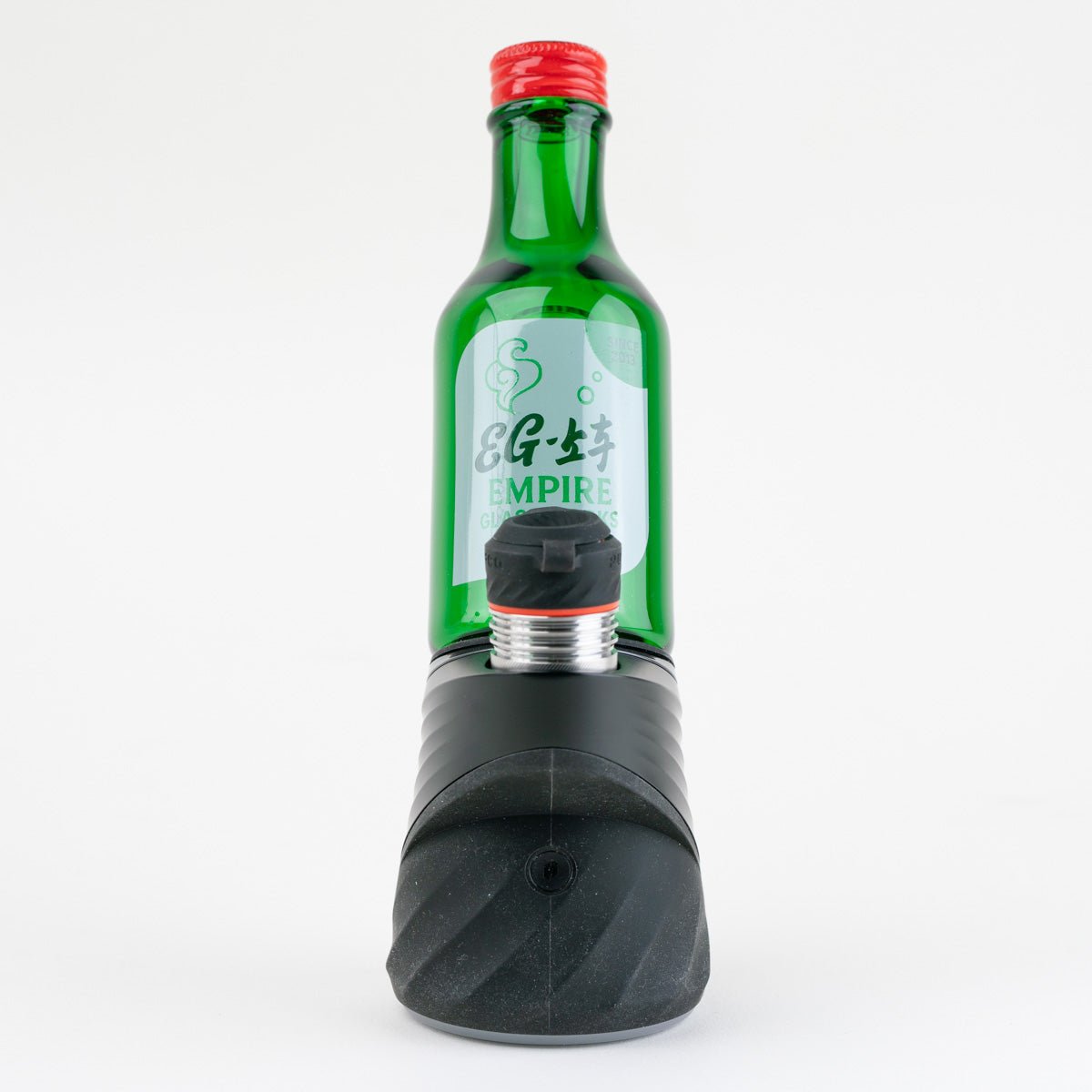 Puffco Peak device fitted with the green Soju Bottle glass attachment filled with water