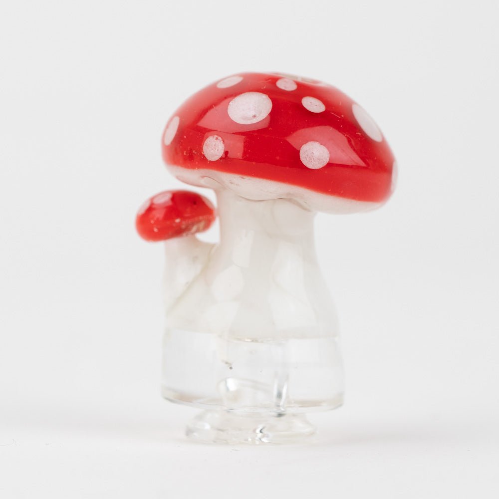 Glass mushroom Puffco Pivot top with a red cap and white spots on a white background