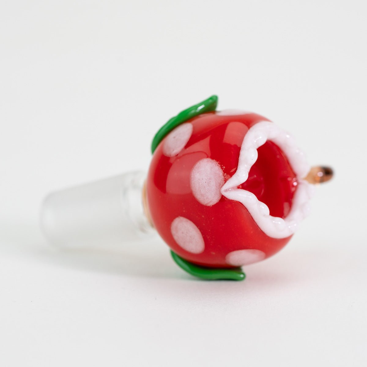 Red and white polka dot plant bowl piece on its side