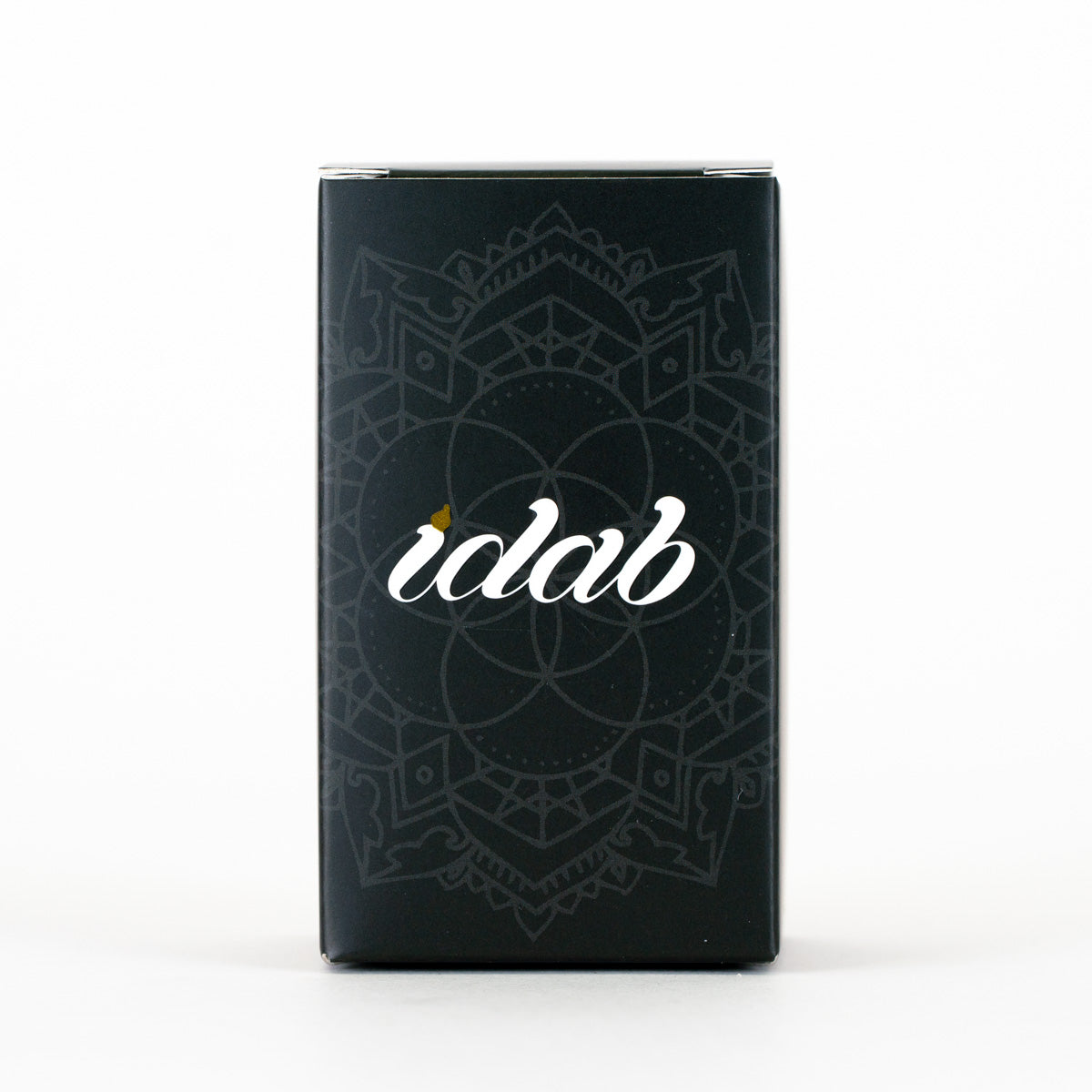 A tall, rectangular black product box with a subtle mandala pattern and the brand name 'idab' in white script on the front, photographed against a clean white background.