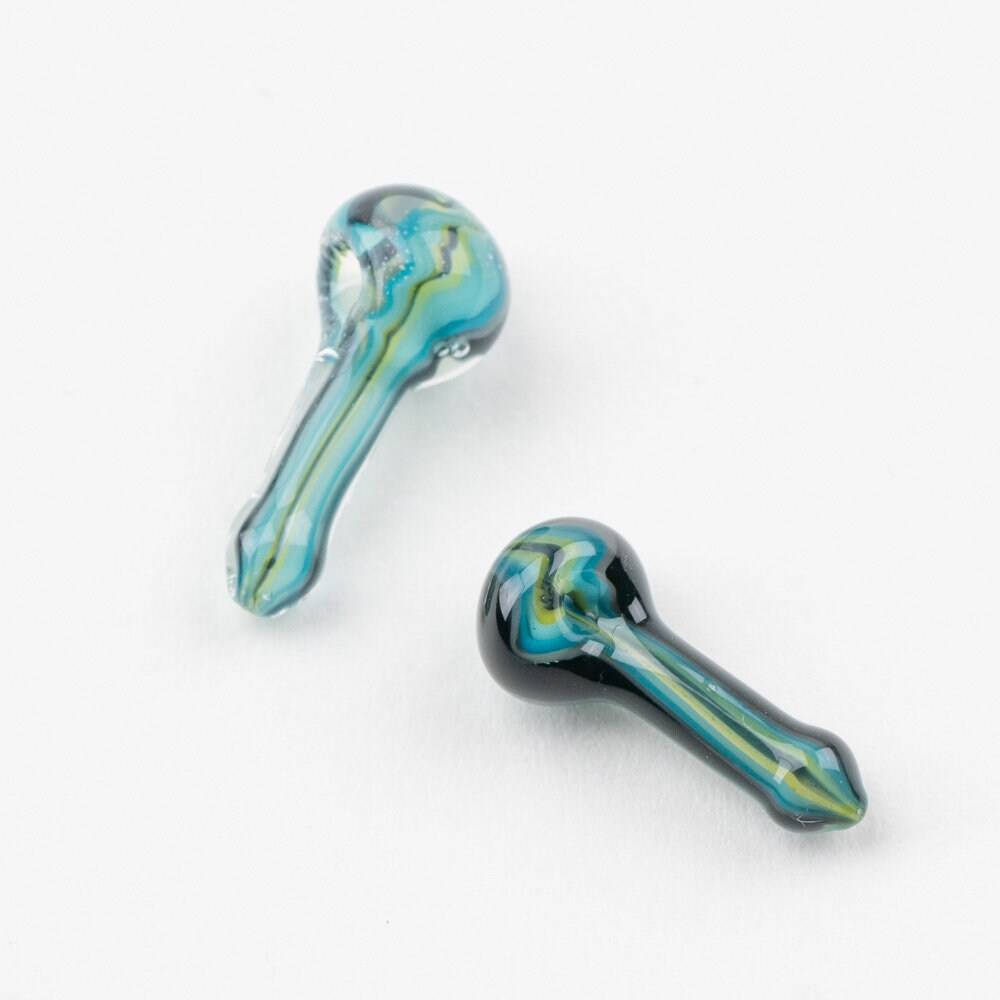 Two pieces of lego spoon pipes, blue and green in color.