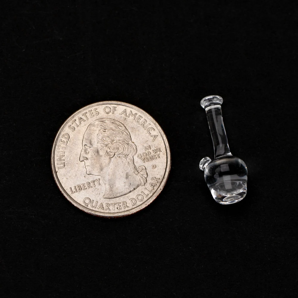 Lego bong laid next to a U.S. quarter for size reference.