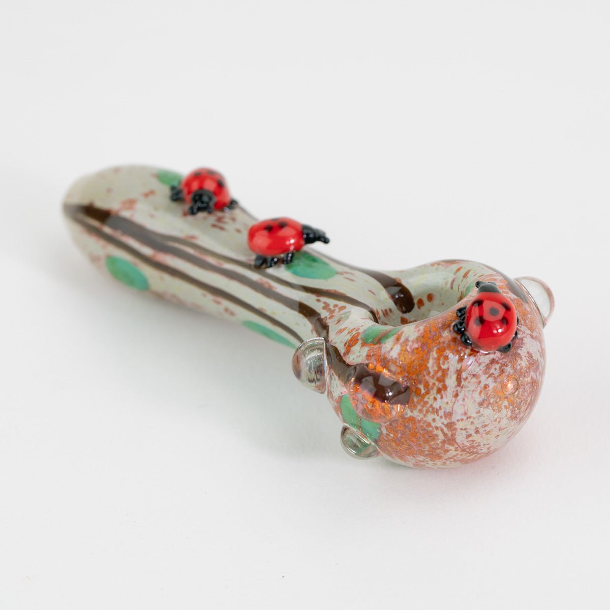 Small spoon pipe on white background with ladybugs