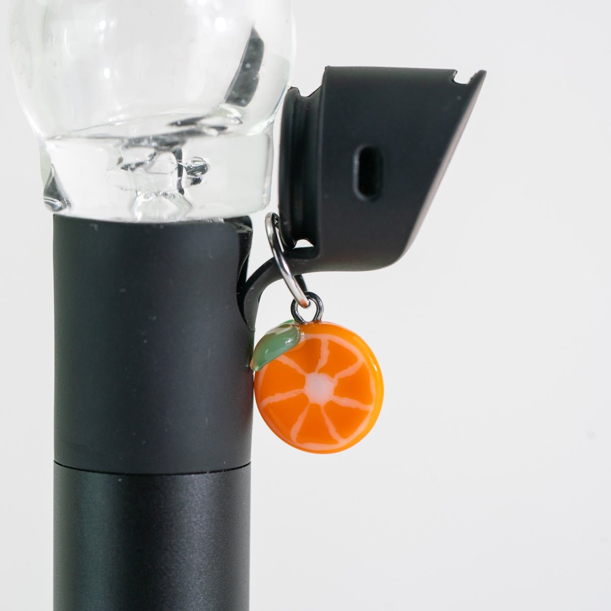 Orange glass Puffco charm with a bright citrus-inspired design
