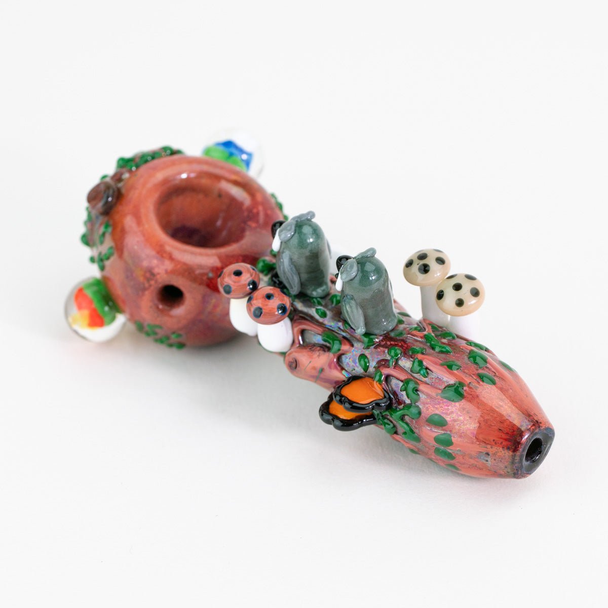 a spoon with owls and nature figurines facing away