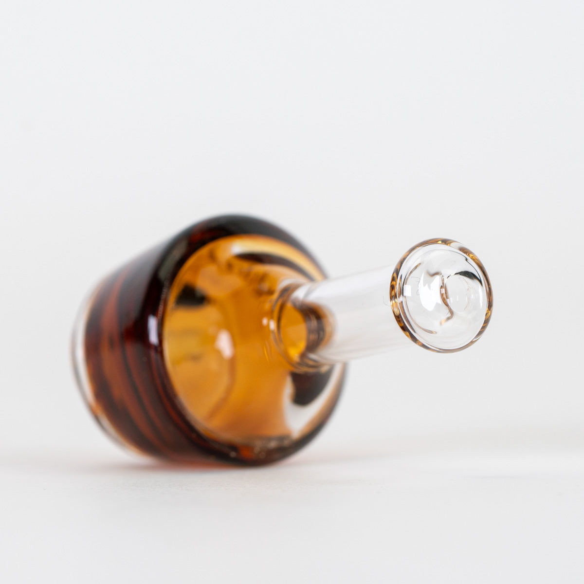 Puffco Pivot mouthpiece with amber bottle shape and clear glass mouthpiece section