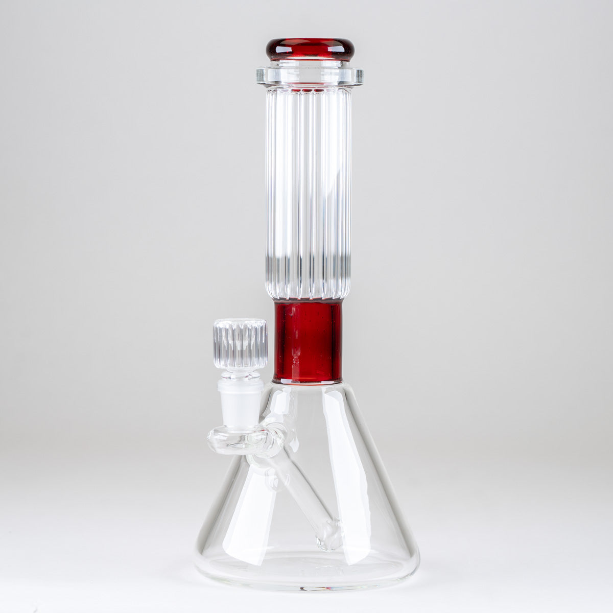 Reverse side view of the Ruby Signature Beaker Bong showing its ribbed glass neck, red accents, and integrated downstem
