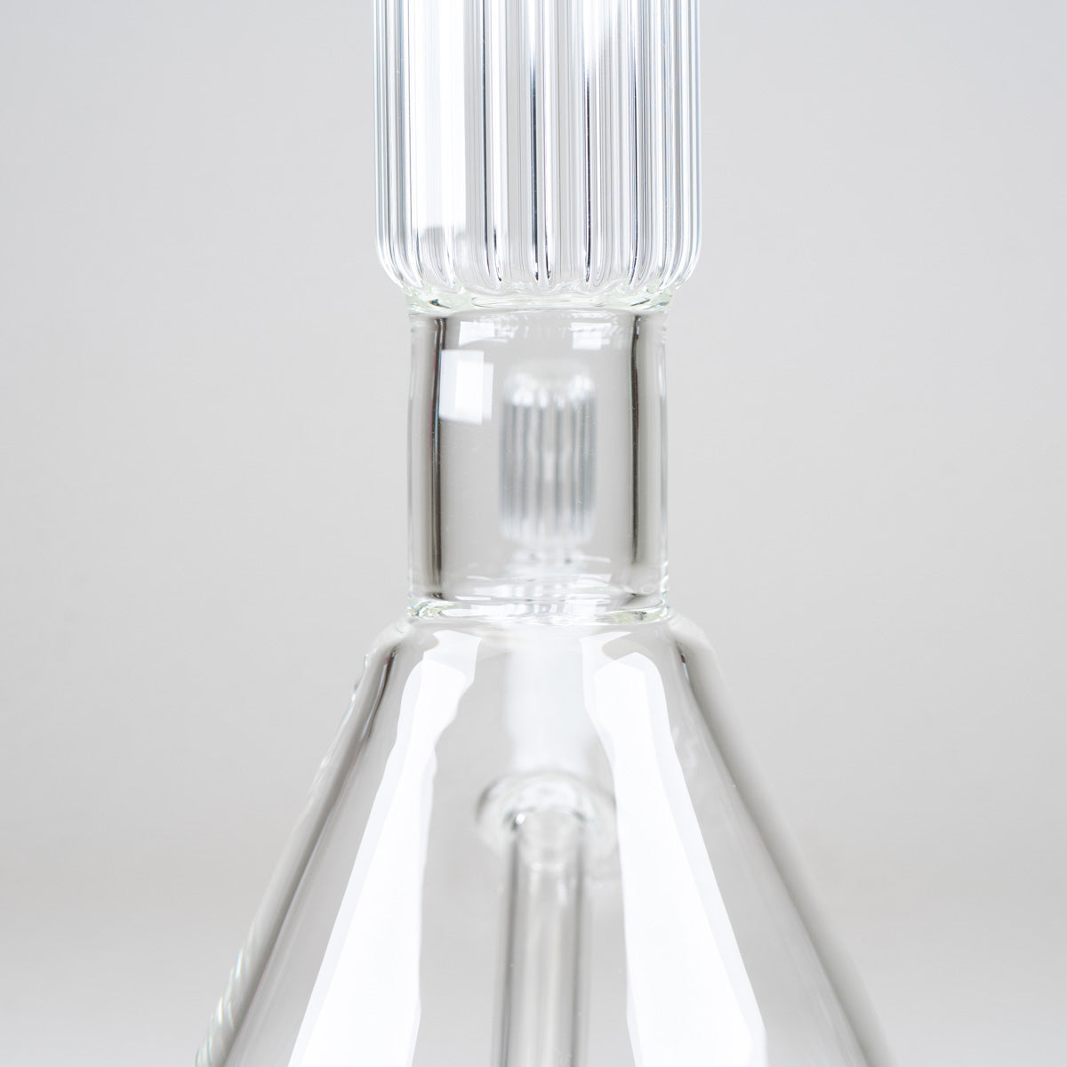 Detailed view of the signature vertical ribbed glass neck and architectural design of the Crystal Beaker Bong
