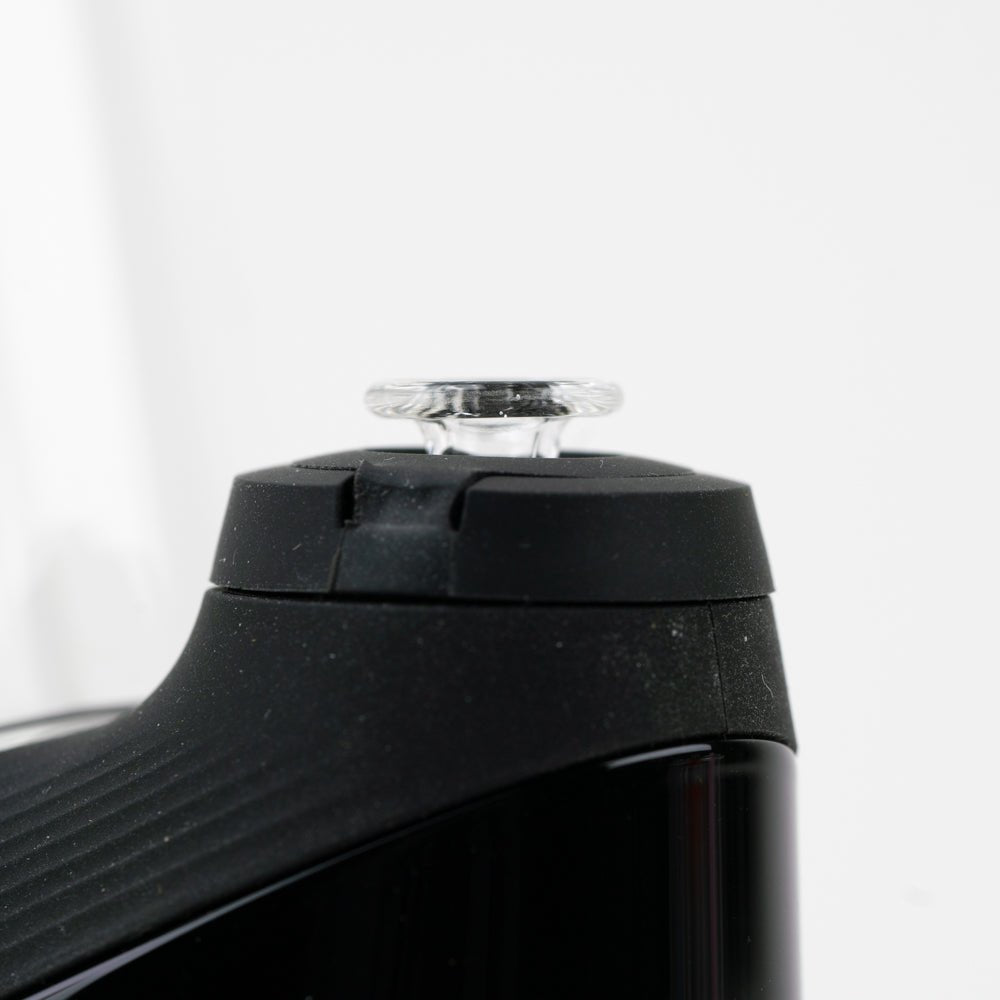 Clear glass Puffco cap that turns pink when exposed to UV light