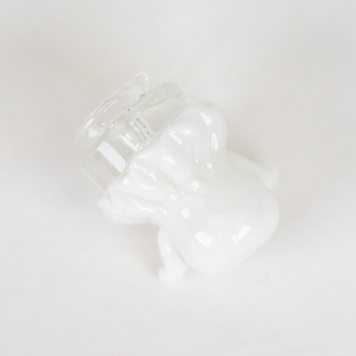 White sculpted ghost glass attachment with clear base on a Puffco Pivot