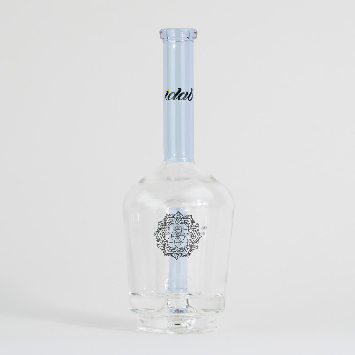 Clear glass bottle with a blue cap and decorative label on a white background
Details