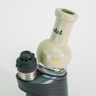 Cream colored glass attachment for Puffco device