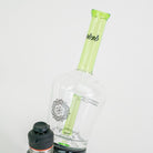 Glass bottle with green cap and black label on a white background