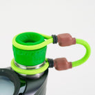 Closeup of green and brown Puffco attachment on white background