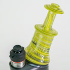 Glass smoking device with black and red accents on a white background