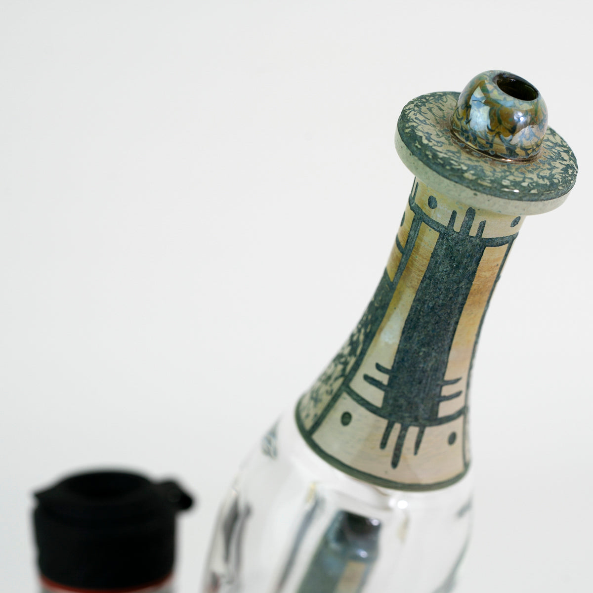 Closeup top of glass water peak attachment on white background 