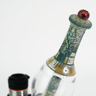 Closeup of glass green engraved water peak accessory