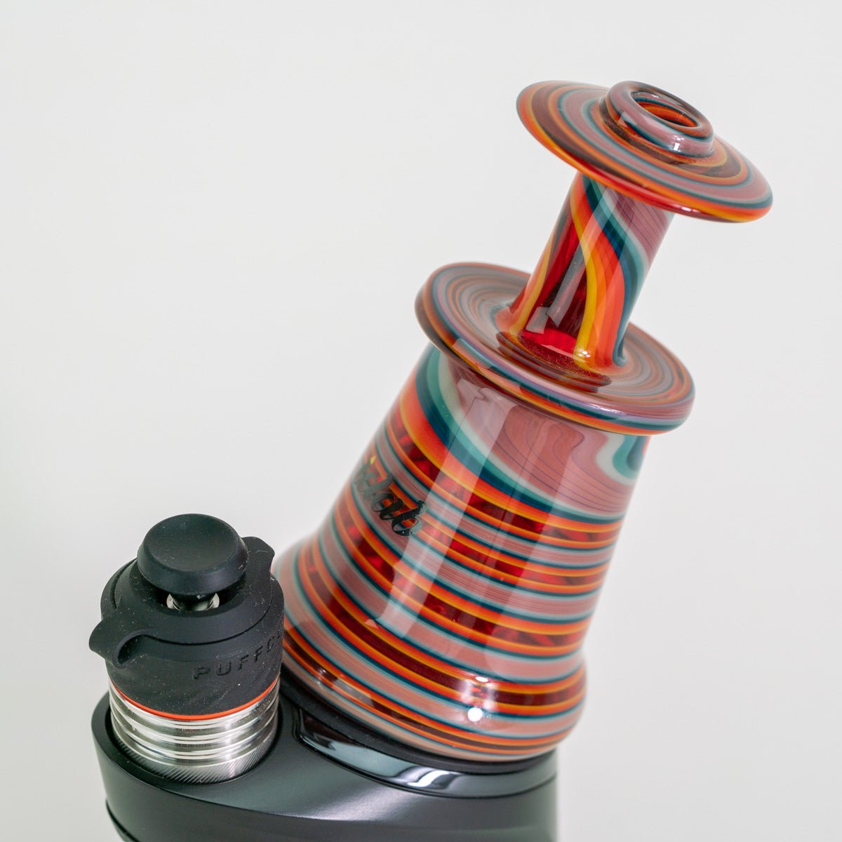 Closeup of colorful glass attachment on Puffco device