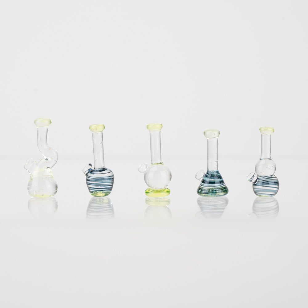 Five piece set of lego bongs on a white back ground. Each bong piece is slightly different shape and color.