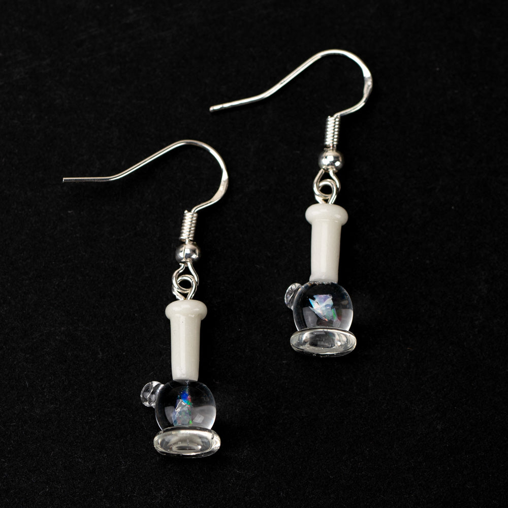 A pair of opal bong dangle earrings on a black background. The water pipe is glass and features an piece of crushed opal on the inside of the pipe. The stem of the earring is white and the earring backing is silver.