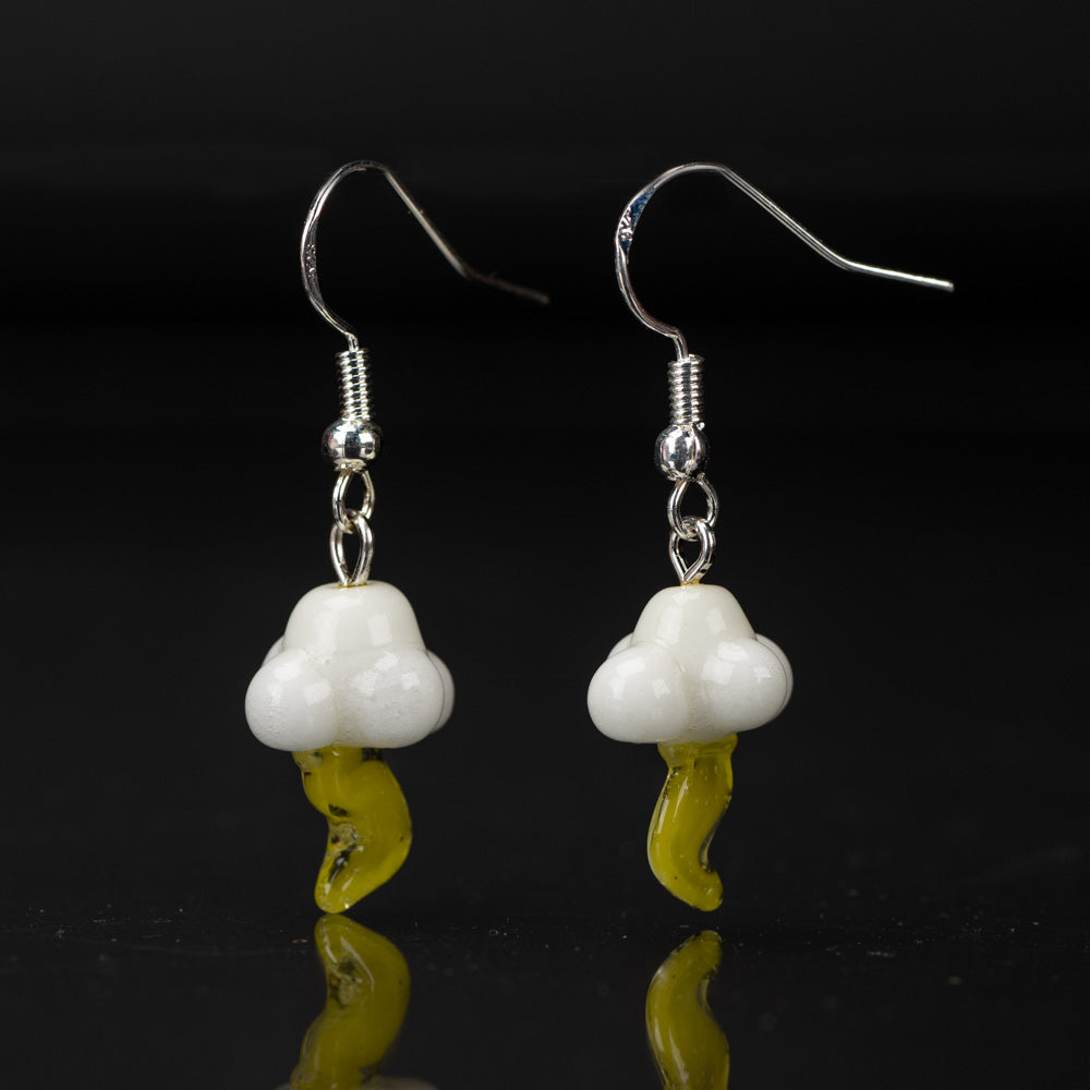 Two dangle style earrings on a black background shaped resembling a cloud and lightning bolt. The cloud and lightning bolt are made of glass. The cloud is a white color glass and the lightning bolt is a yellow color. Above the cloud is a sterling silver dangle backing.