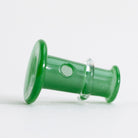 Puffco green joystick laying on white background