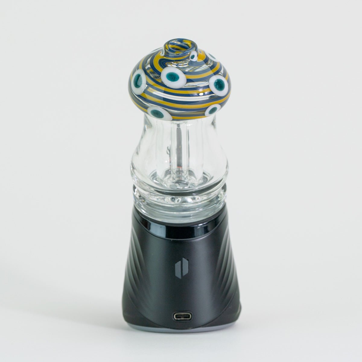 Glass mushroom attachment with blue and white circles on Puffco device