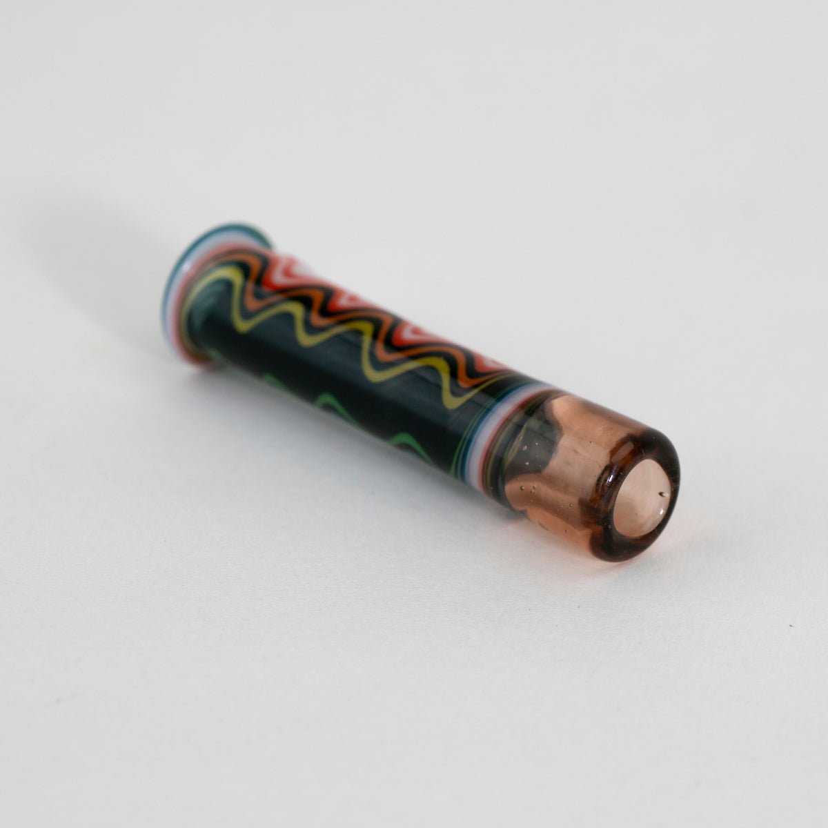 Glass pipe with decorative wavy design on white background