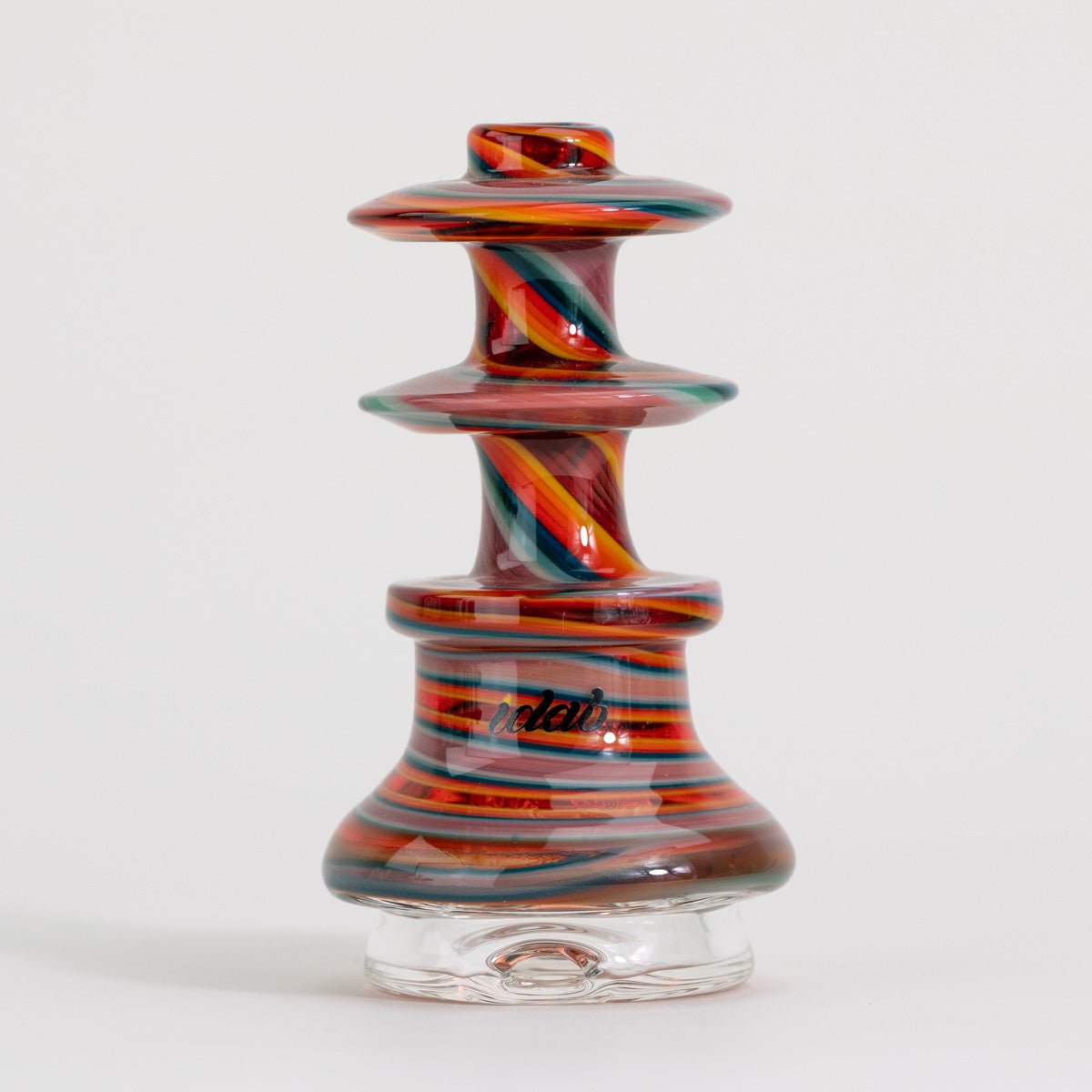 Colorful glass smoking accessory with swirl design on a white background