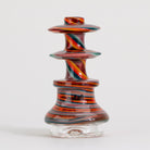 Colorful glass smoking accessory with swirl design on a white background