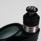 Closeup of engraved joystick accessory on white background