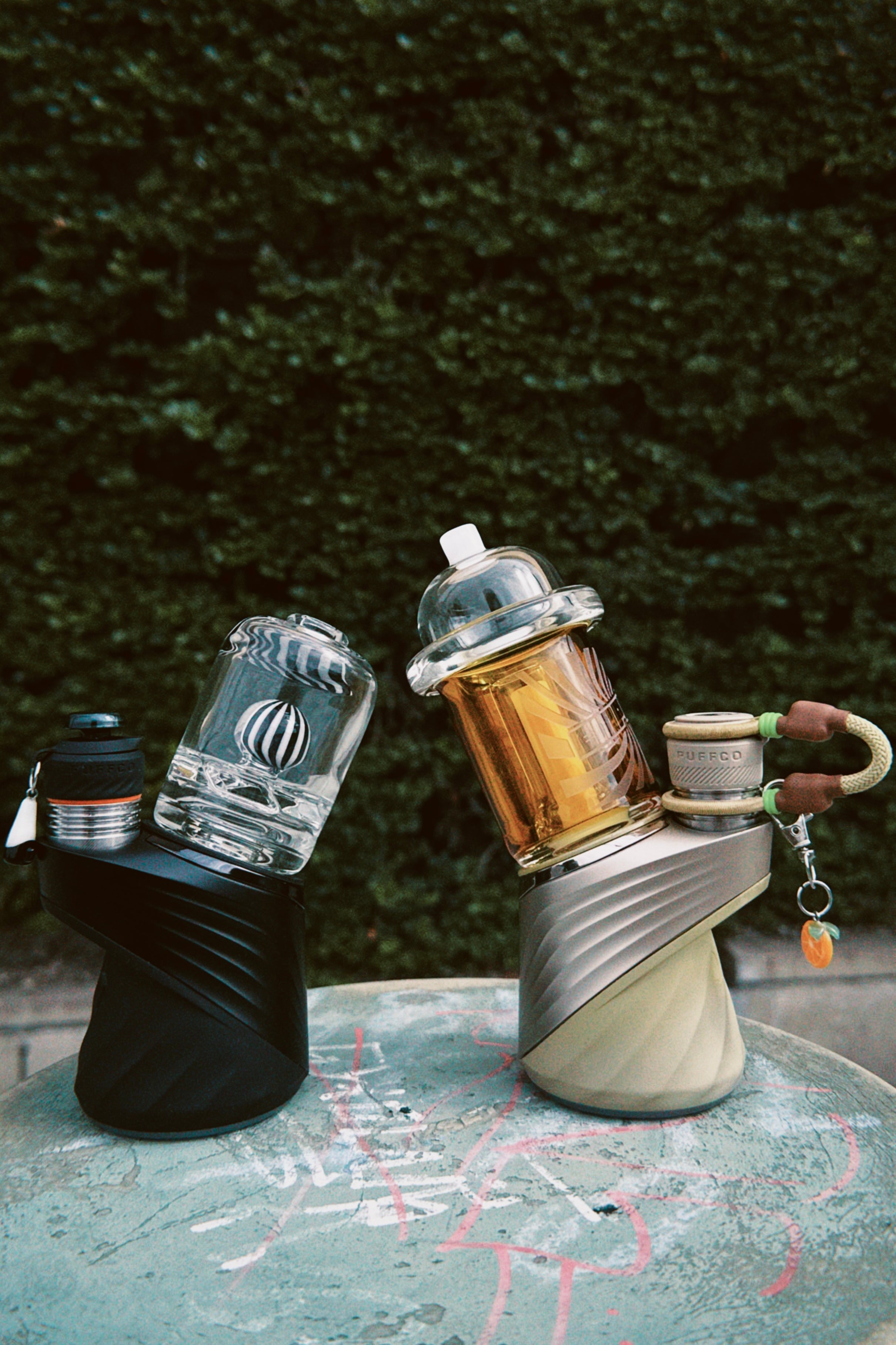 Two glass bottle designs on Puffco device