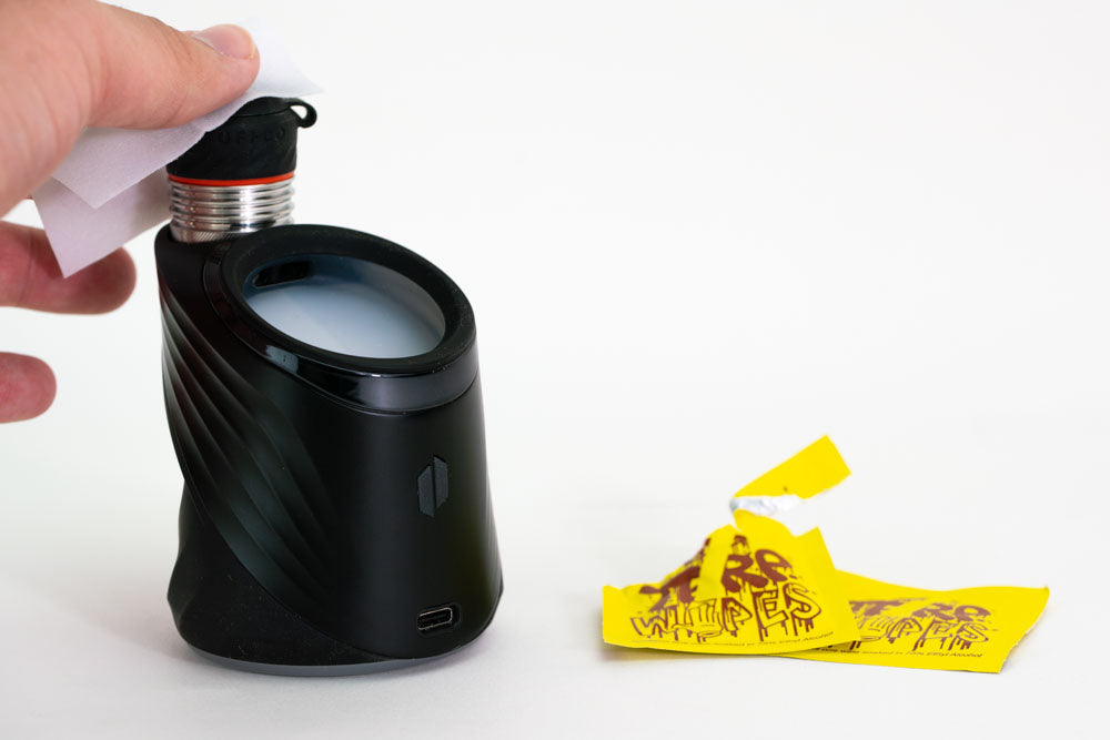 Puffco device being cleaned with wipes