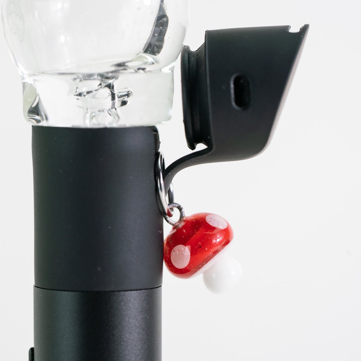 Red mushroom charm on Puffco Pivot mouthpiece device