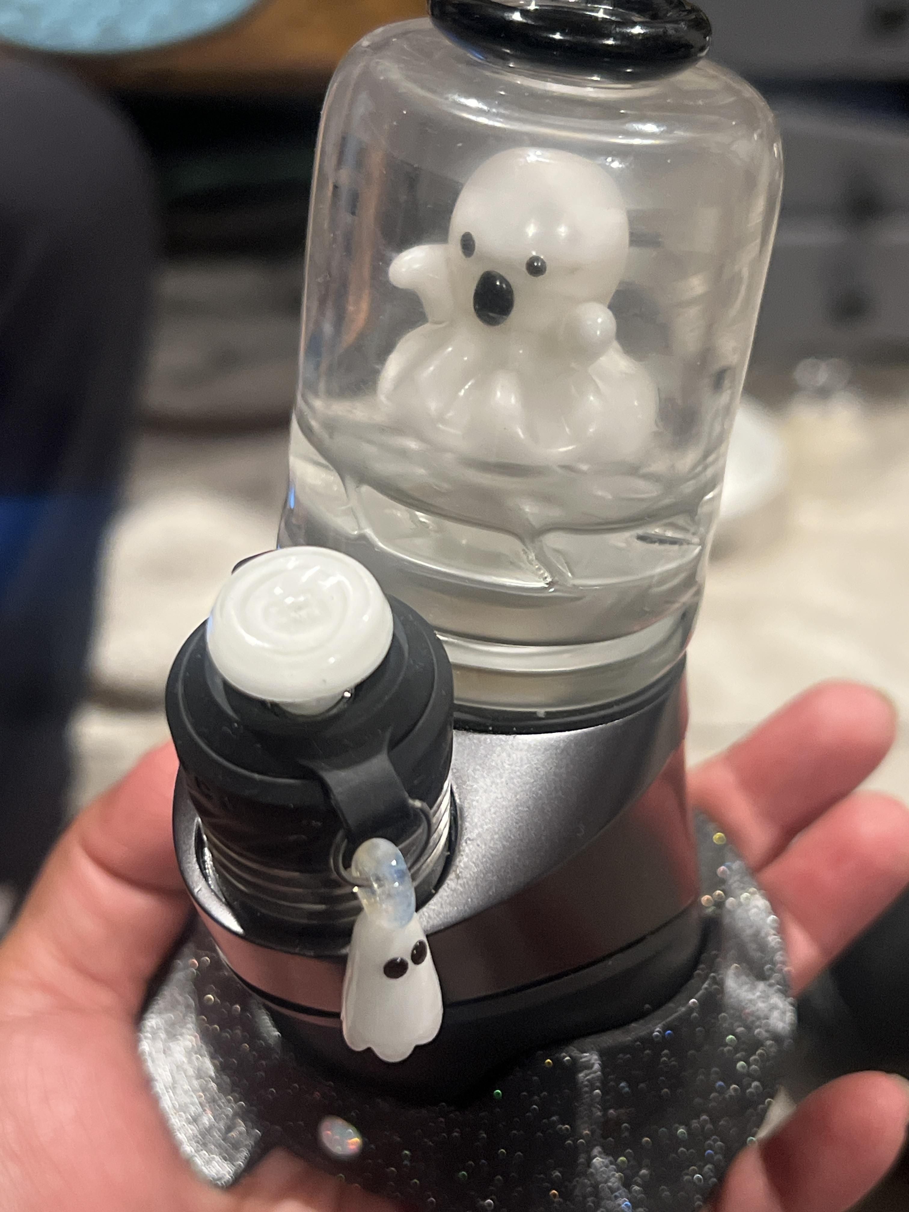 A glow in the dark ghost attachment and joystick on a Puffco Peak Pro device.