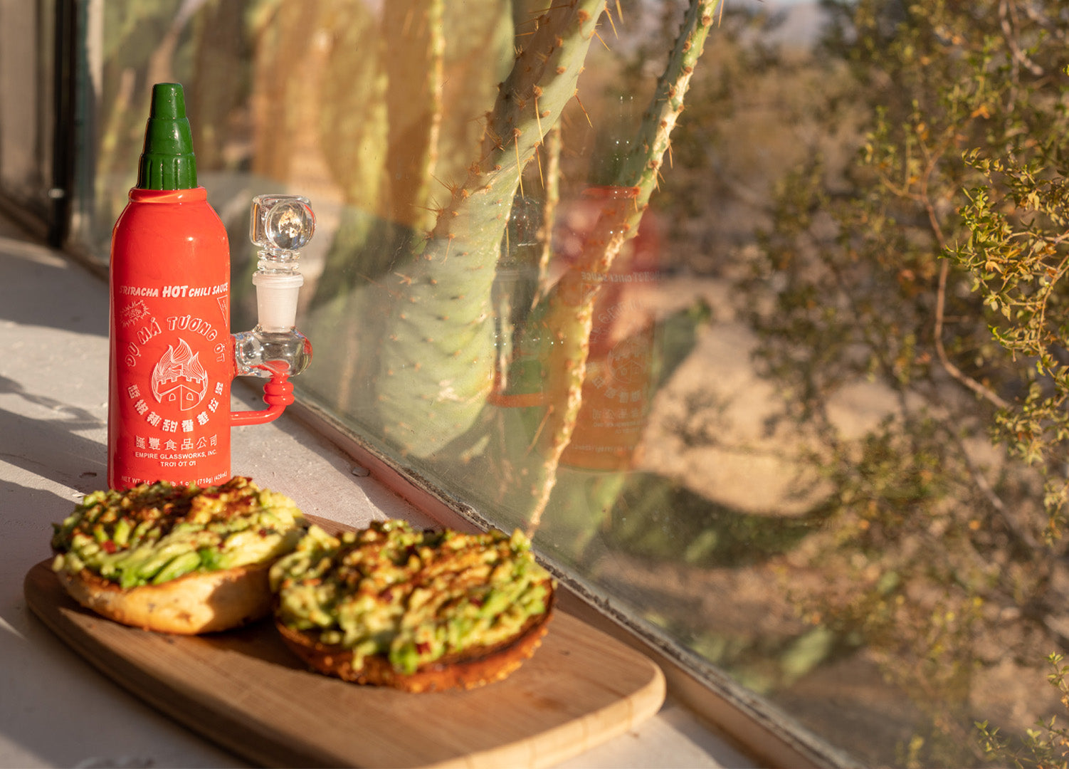Sriracha bong piece with avocado toast on windowsill 